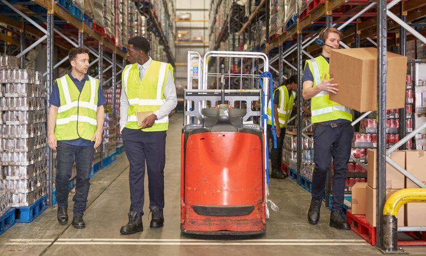 A group of employees places items in the warehouse