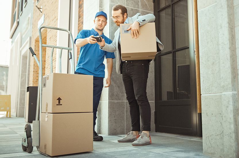 The courier delivers the goods to the customer on a sack truck