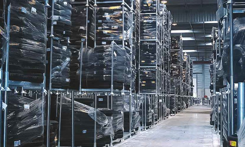 Vehicle tyres are stored on mobile pallet racks.